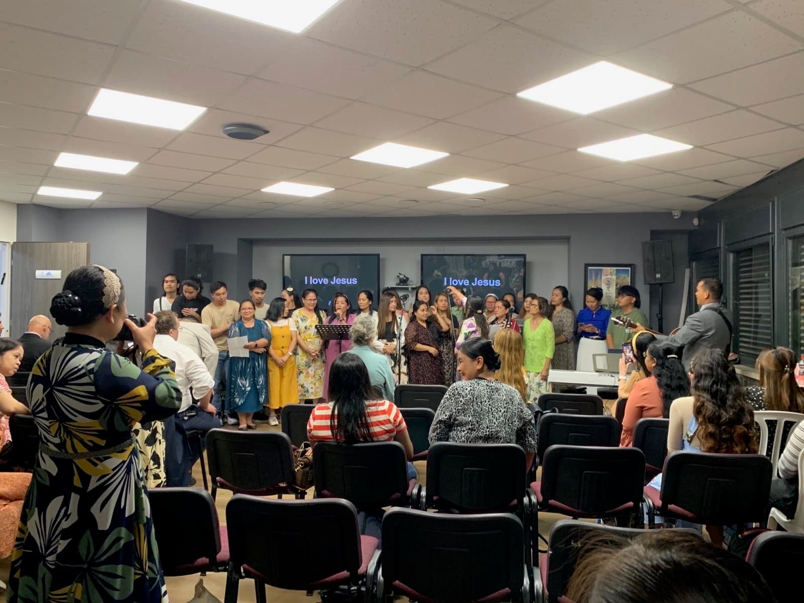 Believers singing in worship at the conference