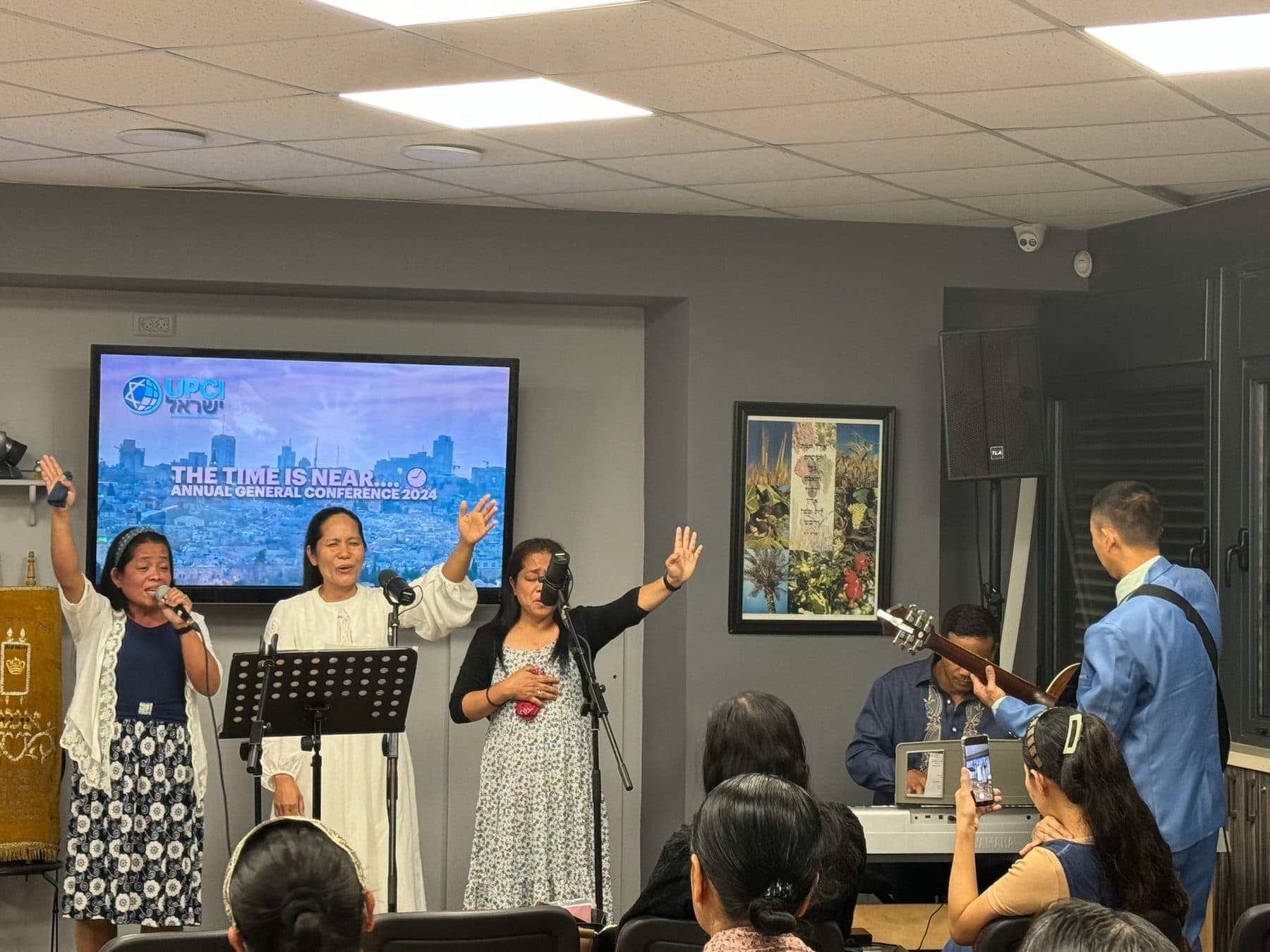 Believers worshipping together with hands raised