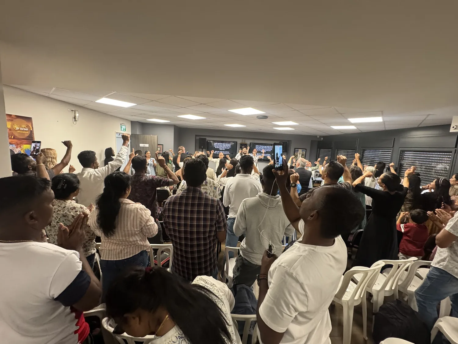 A congregation gathered in worship, prayer and teaching in Israel